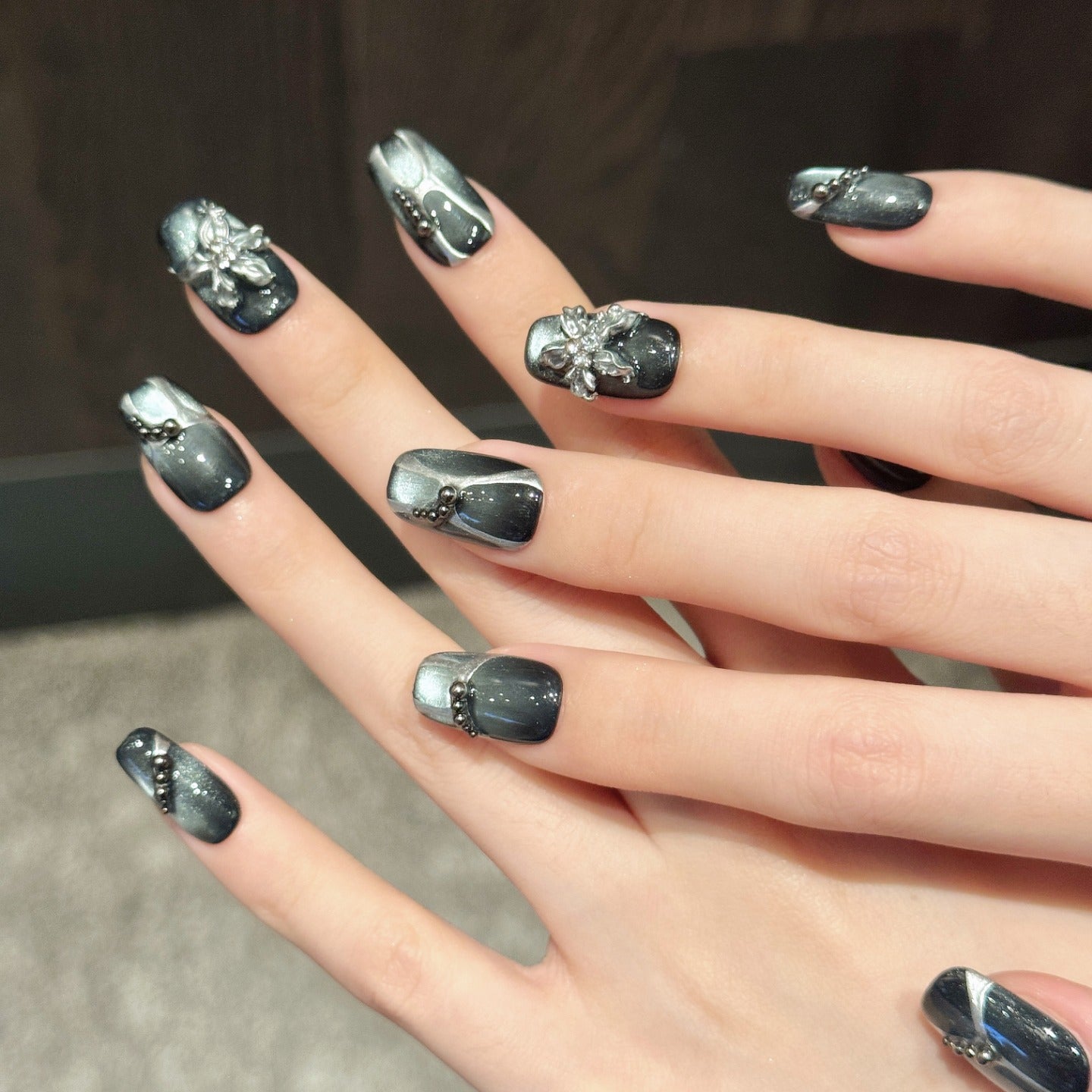Black cat-eye style nail polish and wearable nail pads