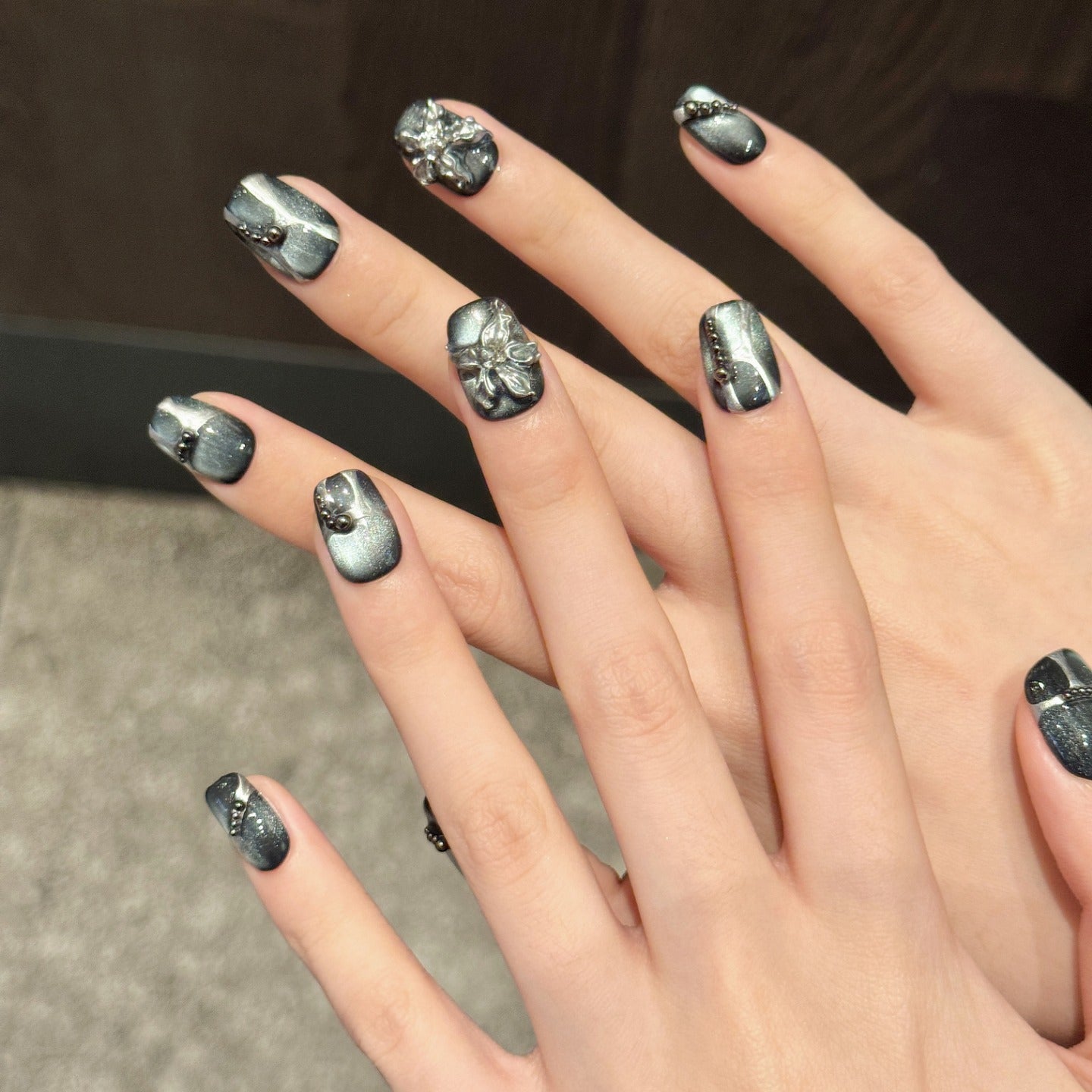 Black cat-eye style nail polish and wearable nail pads