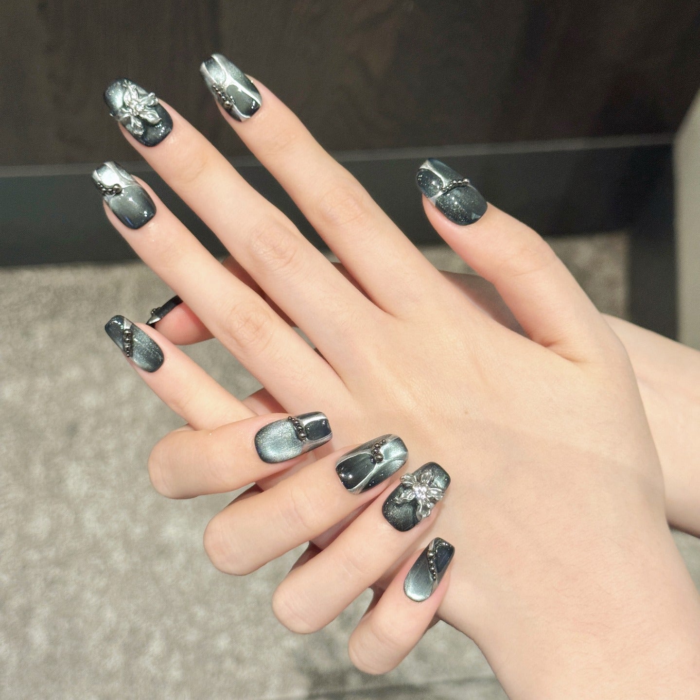 Black cat-eye style nail polish and wearable nail pads