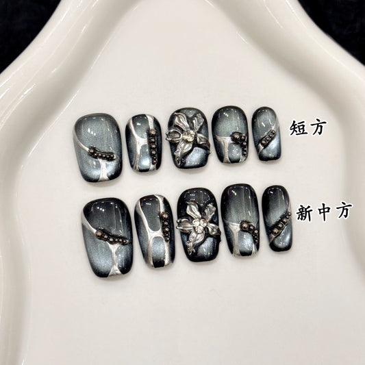 Black cat-eye style nail polish and wearable nail pads